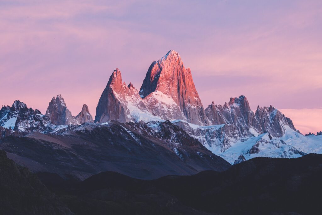 Patagonia Hiking Guide: a mountain range with a pink sky in the background