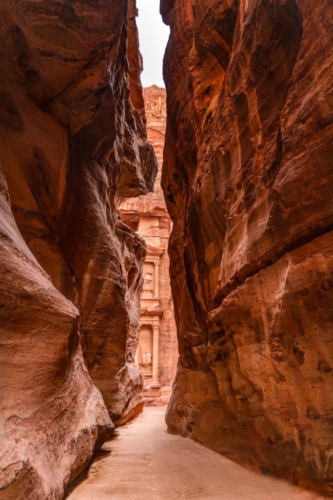 Petra Travel Guide: A narrow, ancient rock canyon leading to the famous Petra Treasury in Jordan.