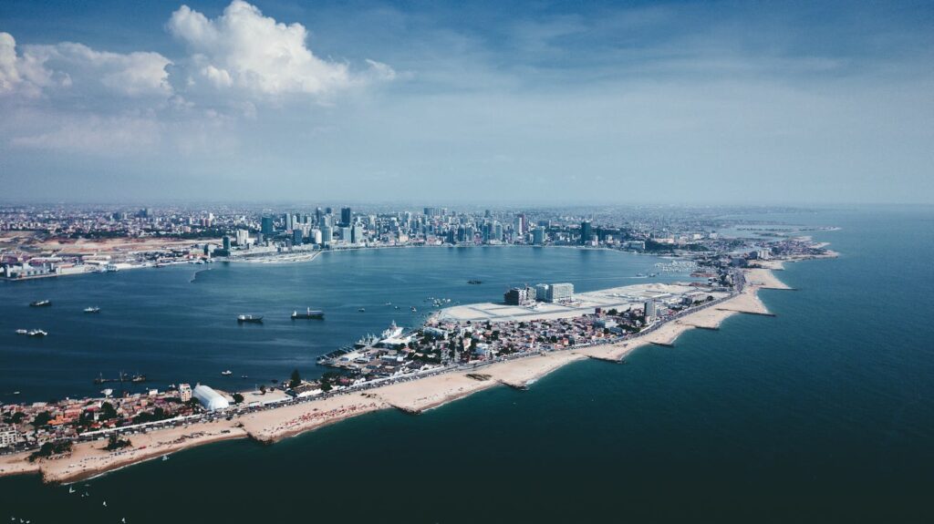 African Hidden Gems: Stunning aerial shot of Luanda's coastline and urban skyline under a blue sky.