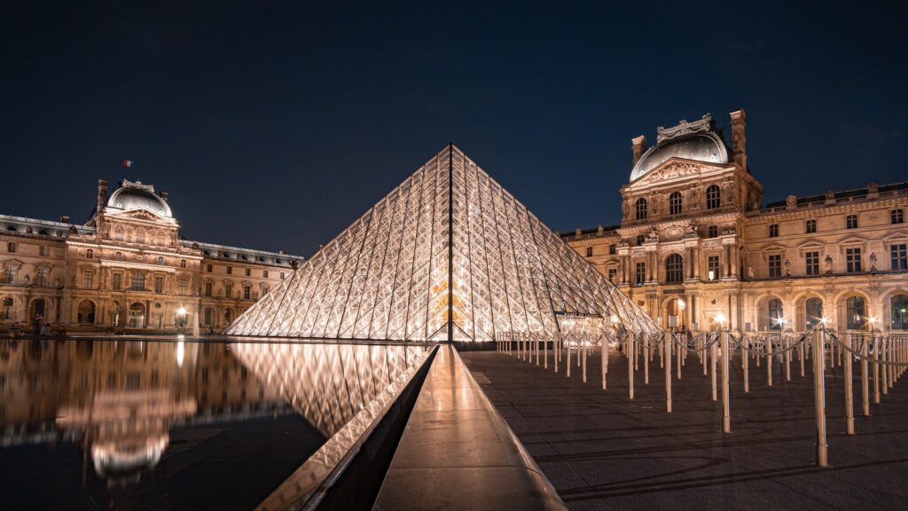 Paris on a Budget: Louvre, brown concrete building during night time