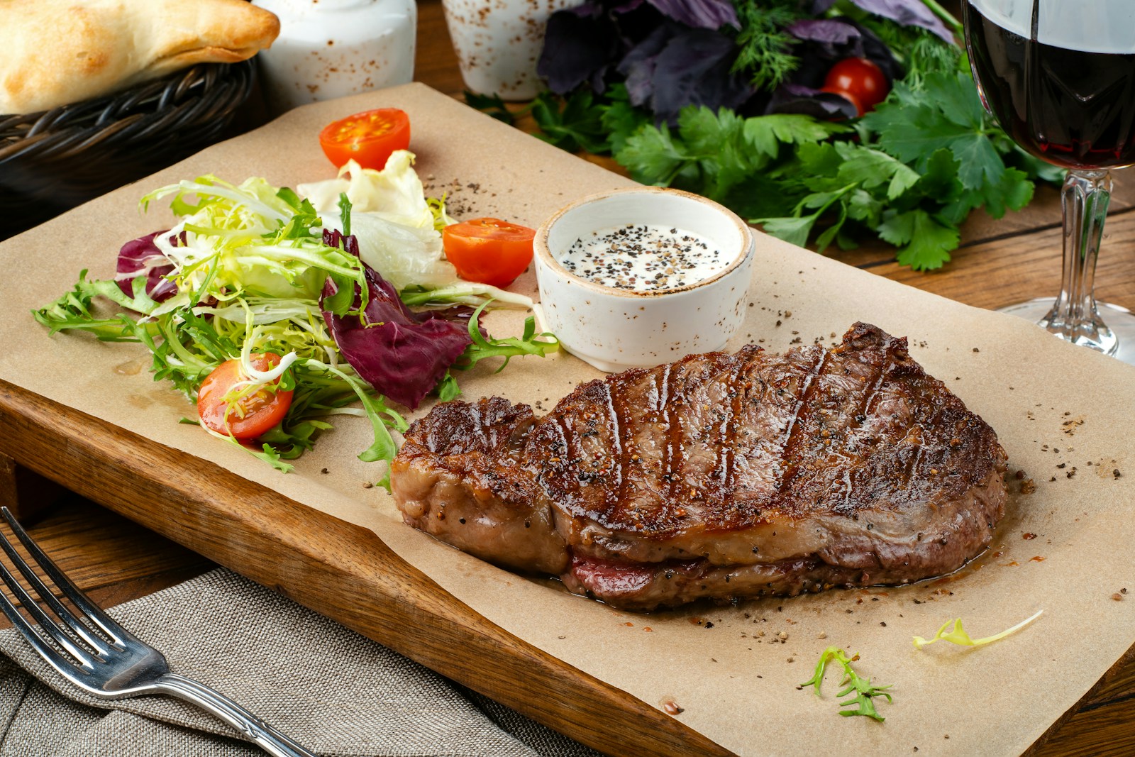 Australia and New Zealand Food Guide: a steak with a side of salad and a glass of wine