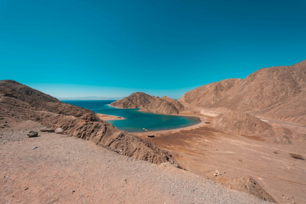 Sinai Peninsula: brown mountain near blue sea under blue sky during daytime