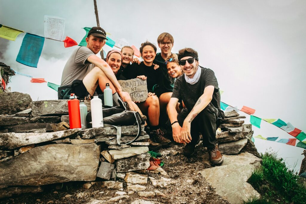 Solo Travel Safety Tips: group picture of men and women on hill at daytime