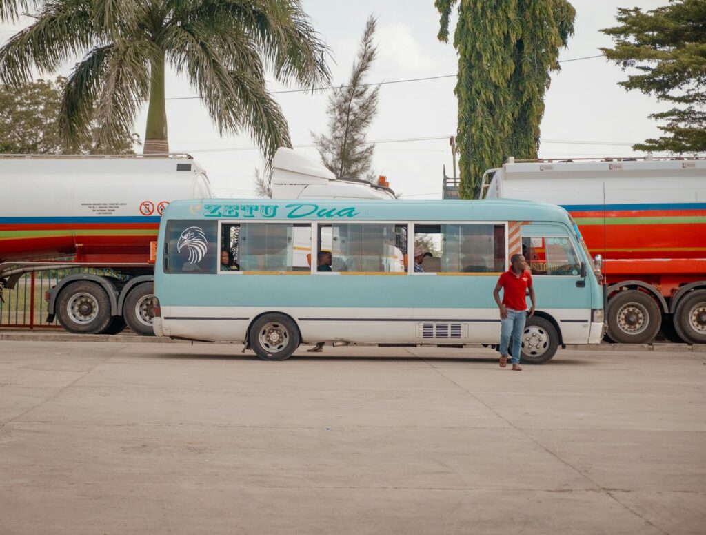 budget travel in Africa: a person standing next to a bus