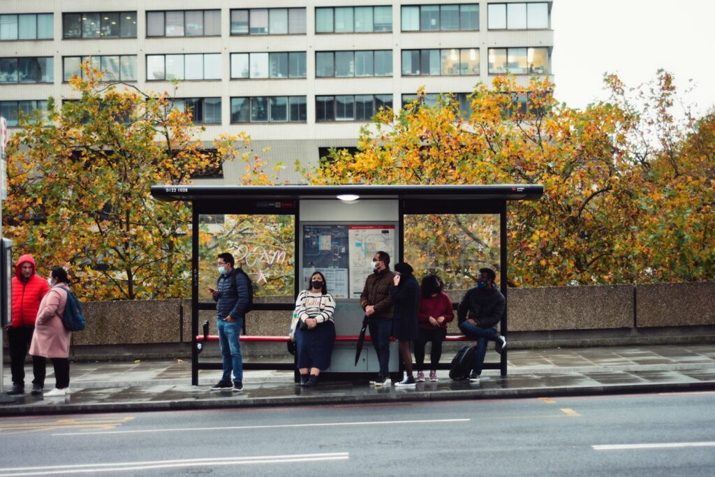 Solo Travel Safety Tips: people sitting on bench in front of building during daytime