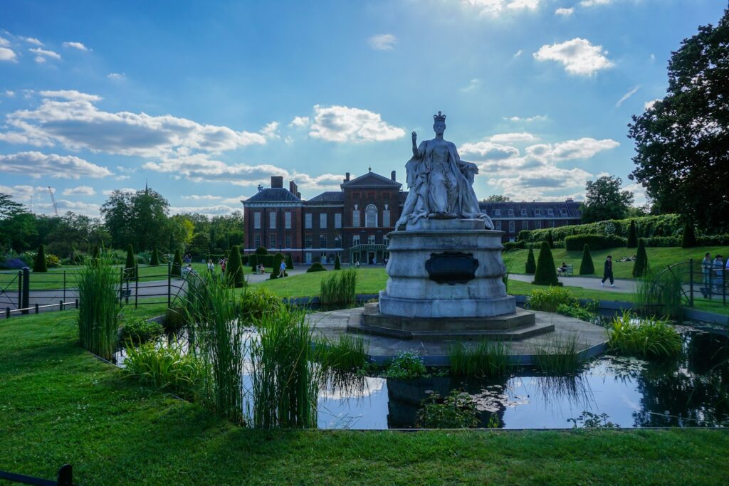 London travel tips: a statue in the middle of a park with a building in the background