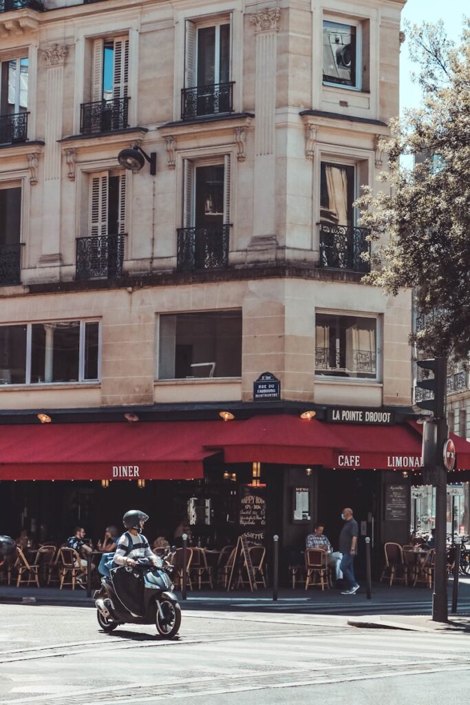 Paris on a Budget: café, brasserie, people walking on street near building during daytime