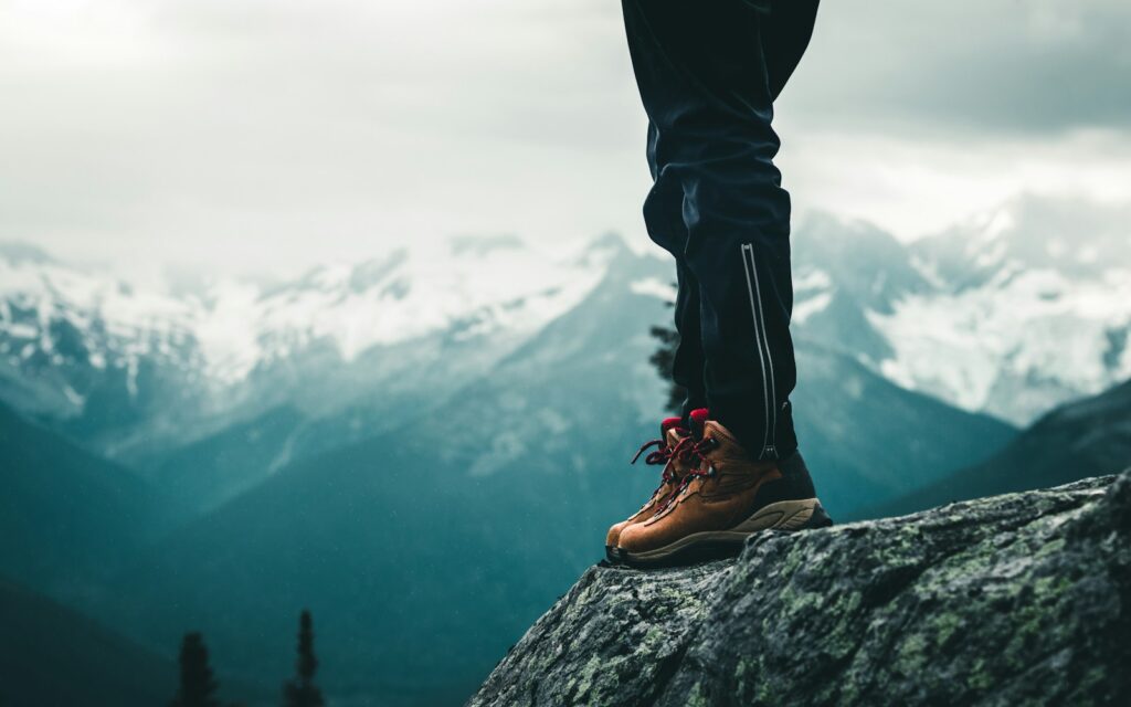 Patagonia Hiking Guide: person in black pants and brown leather shoes standing on rock