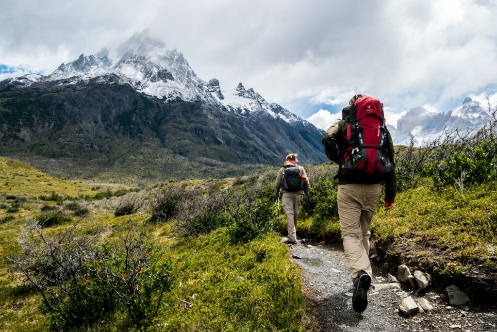 Patagonia Hiking Guide: two person walking towards mountain covered with snow